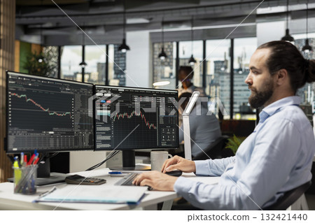 Portfolio manager reviews asset performance and adjusts holdings for optimal growth. Financial expert oversees diversified investment portfolios to maximize returns for clients Portfolio manager reviews asset performance and adjusts holdings for optimal growth. Financial expert oversees diversified investment portfolios to maximize returns for clients 132421440