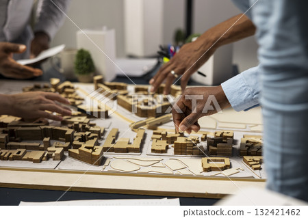 Team of real estate developers planning modern residential project, ensuring 3D models and market insights to prepare for site development and zoning regulations approval. Property investment. 132421462