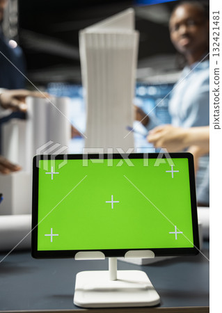 Close up of isolated green screen running on tablet in a briefing office, housing project construction details with architectural 3d models. Real estate experts discuss rules and zoning regulations. 132421481