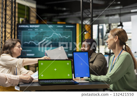 Group of business managers gathering near isolated copy space in work environment, perfect for custom organizational graphics, finance charts or analytics overlays for performance reports. 132421550