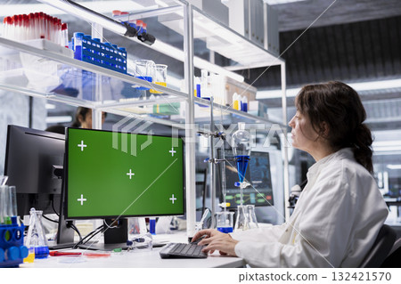 Lab technician looking at 3D molecular model visualization on green screen computer monitor. Woman using bioengineering software on chroma key PC in medical lab displaying DNA data, Lab technician looking at 3D molecular model visualization on green screen computer monitor. Woman using bioengineering software on chroma key PC in medical lab displaying DNA data, 132421570