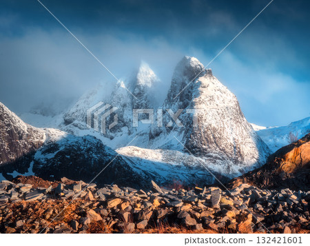 Snow-capped mountain peaks in low clouds at sunrise in winter Snow-capped mountain peaks in low clouds at sunrise in winter 132421601