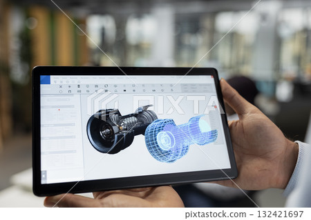 Close up of engineer using tablet to review turbine data, saving energy and lowering costs. Sustainability expert in office using touchscreen digital device to evaluate turbine environmental impact 132421697