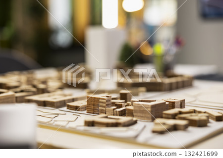 Quiet empty office space in a modern real estate development firm shows 3D models urban layout on table, architecture design tools used in housing and redevelopment planning. Master plan. 132421699