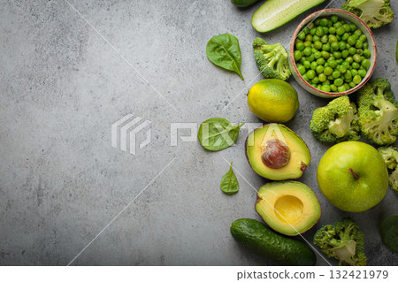 Fresh green vegetables and fruit grey concrete background top view, diet, vegetarian copy space Fresh green vegetables and fruit grey concrete background top view, diet, vegetarian copy space 132421979