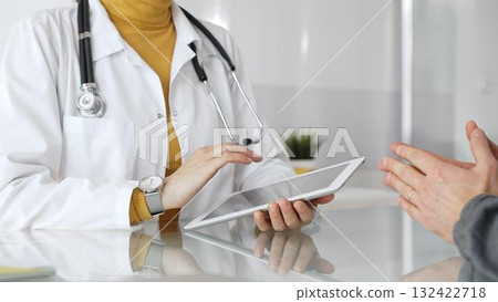 Doctor consulting patient using digital tablet, explaining medical information during modern healthcare appointment. Medicine, healthcare and science concept Doctor consulting patient using digital tablet, explaining medical information during modern healthcare appointment. Medicine, healthcare and science concept 132422718