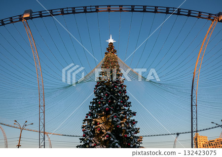 Christmas tree and New Year decorations on the town square on a frosty winter day. Christmas tree and New Year decorations on the town square on a frosty winter day. 132423075