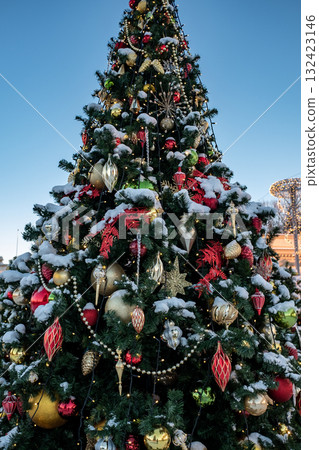 Christmas tree and New Year decorations on the town square on a frosty winter day. Christmas tree and New Year decorations on the town square on a frosty winter day. 132423146