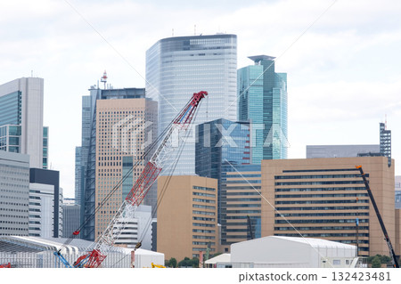 A landscape of large cranes and skyscrapers A landscape of large cranes and skyscrapers 132423481