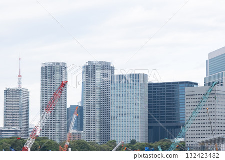 A landscape of large cranes and skyscrapers A landscape of large cranes and skyscrapers 132423482