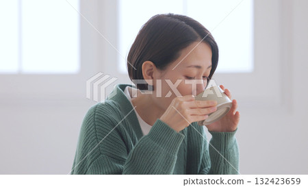 Middle-aged woman holding a mug 132423659