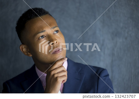 A foreign man wearing a suit and thinking 132423707