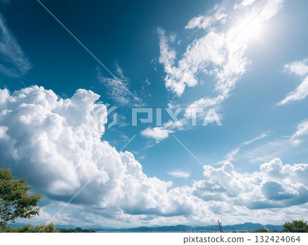 A beautiful summer landscape of blue skies, cumulonimbus clouds, and sunshine. 132424064