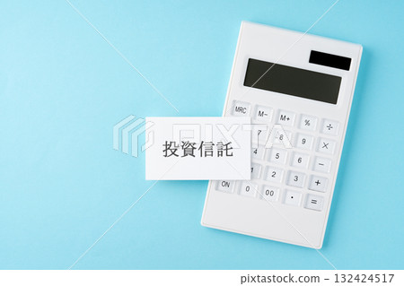 Investment trust word and calculator on light blue background 132424517