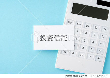 Investment trust word and calculator on light blue background 132424518