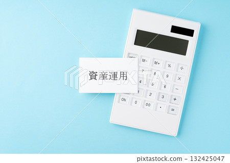 Asset management text and calculator on light blue background 132425047