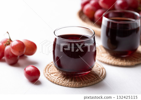 Red grape juice in glass and fresh grapes fruit on white background, Healthy drink Red grape juice in glass and fresh grapes fruit on white background, Healthy drink 132425115