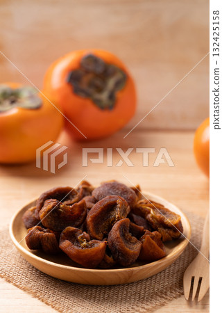 Dried persimmon on wooden plate ready to eating, Sweet and chewy 132425158