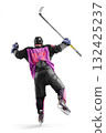 Hockey player in action. Hockey champion seen rear view. A very emotional hockey player with a stick and puck in his hands. Isolated. Sports emotions 132425237
