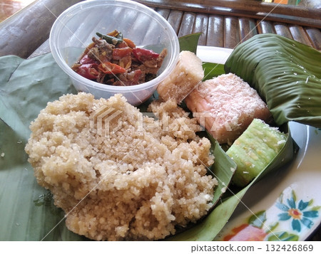 Traditional Indonesian Food: Tiwul Rice and Snacks Served on Banana Leaf 132426869