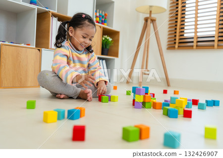 toddler girl playing block toy cubes at home 132426907