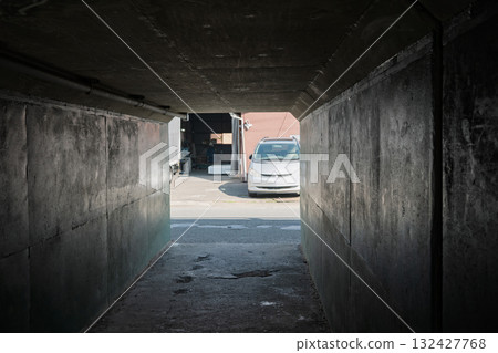 Beyond the dark culvert, vestiges of Japan's period of rapid economic growth shine. 132427768