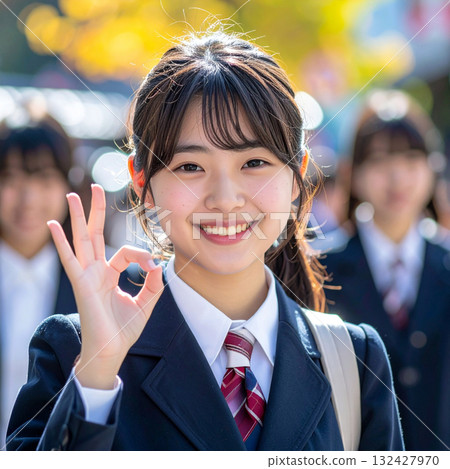 A cute high school girl smiling and giving an OK sign A cute high school girl smiling and giving an OK sign 132427970
