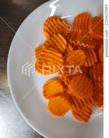 Orange Swirled Carrot Chips On White Plate For Healthy Snack Photography Orange Swirled Carrot Chips On White Plate For Healthy Snack Photography 132427993