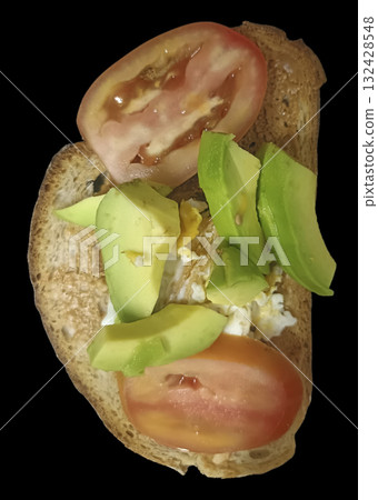 Avocado and tomato toast with scrambled egg on whole grain bread, bright fresh breakfast scene with vibrant color and appetizing texture 132428548