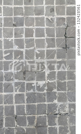 Worn gray stone tile floor grid pattern cracked grout square paving textured surface urban walkway weathered pavement concrete tiles Worn gray stone tile floor grid pattern cracked grout square paving textured surface urban walkway weathered pavement concrete tiles 132428561