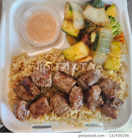 Assorted Grilled Meats, Shrimp, Vegetables, and Rice in Takeout Container with Sweet Sauce 132430298