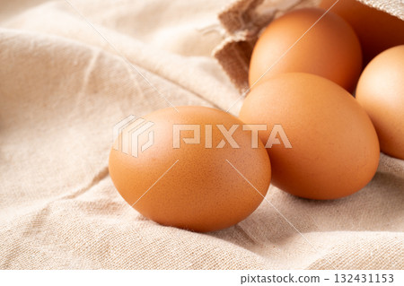 Close-up of a chicken egg (akadama) placed on a cloth 132431153