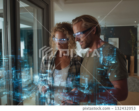 Couple wearing augmented reality glasses exploring holographic home design interface with glowing cityscape projection and focused collaborative Couple wearing augmented reality glasses exploring holographic home design interface with glowing cityscape projection and focused collaborative 132432053