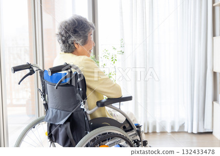 Senior women riding a wheelchair Senior women riding a wheelchair 132433478