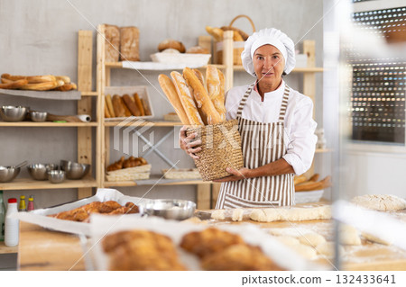 Portrait of positive mature woman bakery worker 132433641