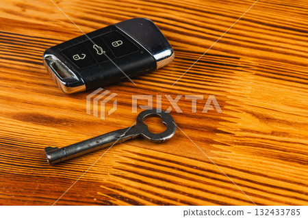 Key and car remote on a wooden table with a smooth finish 132433785