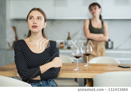 Two women have unpleasant conversation in dining room Two women have unpleasant conversation in dining room 132433860