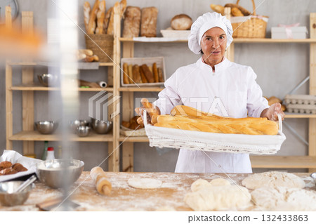 Portrait of positive mature woman bakery worker Portrait of positive mature woman bakery worker 132433863