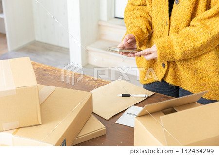 Hands of a woman packing Hands of a woman packing 132434299