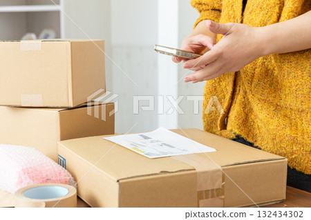 Hands of a woman packing 132434302