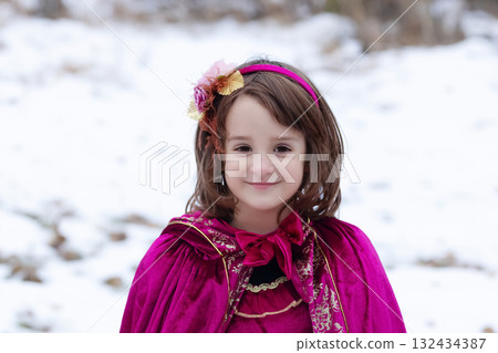 Girl in a Halloween costume of a princess in woods, long red dress. 132434387