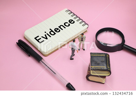 A notepad with the word "Evidence" written on it 132434716