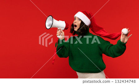 Excited woman in Santa hat holding megaphone and shouting. Excited woman in Santa hat holding megaphone and shouting. 132434748