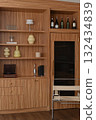Elegant home bar with wooden furniture and luxury interior design. modern storage unit features wine cooler, shelving for decoration, and sophisticated cabinetry 132434839