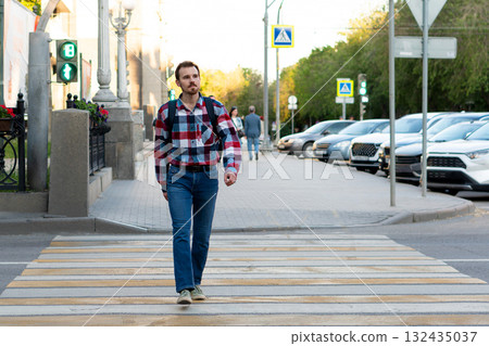 Man crossing street at pedestrian crosswalk in city center Man crossing street at pedestrian crosswalk in city center 132435037