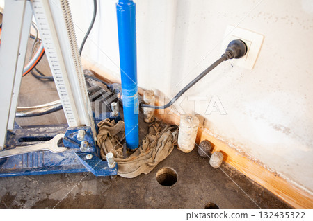 Diamond drill on tripod 132435322