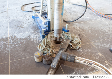 Diamond drill on tripod 132435329