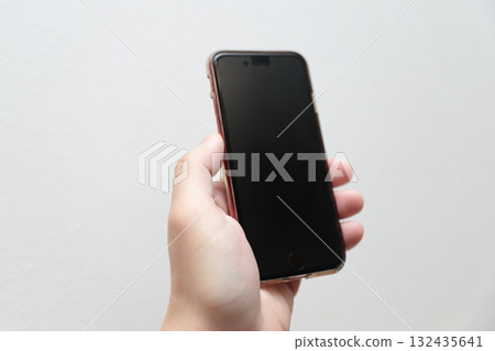 Male hand holding a smartphone 132435641