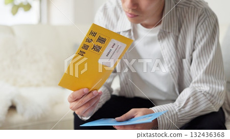 Asian man checking a collection notice Asian man checking a collection notice 132436368