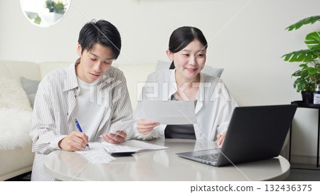 Asian couple checking shopping receipt 132436375
